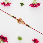 Designer Rakhi With Veena And Flower Charm thumbnail 1
