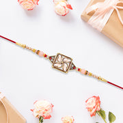 Designer Rakhi With Swastik-inspired Kundan Dial And Decorative Beads thumbnail 3