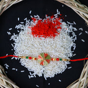Traditional Rakhi With Bright Floral Centerpiece And Decorative Thread thumbnail 1