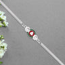 Shiny Silver Rakhi With Ganesha Emblem And Elegant Dual Chain Design