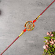 Intricately Designed Circular Rakhi With Multicolor Accents And Red Thread For Rakshabandhan thumbnail 1