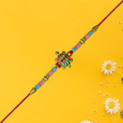 Turtle Design Rakhi With Floral Accents And Beads thumbnail 1