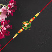 Green Tulsi Leaf Rakhi With Orange Enamel Flower And Beaded Thread thumbnail 3