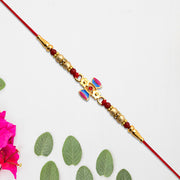 Damru Rakhi With Beads And Floral Detailing thumbnail 3