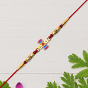 Damru Rakhi With Beads And Floral Detailing thumbnail 1