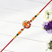 Golden Ganesha Rakhi With Red-green Beads And Stone Detailing thumbnail 2