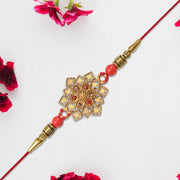 Traditional Golden Floral Rakhi With Intricate Design And Red Beads On Red Thread thumbnail 1