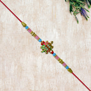 Turtle Design Rakhi With Floral Accents And Beads thumbnail 2
