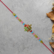 Turtle Design Rakhi With Floral Accents And Beads thumbnail 3