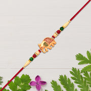 Golden Elephant Rakhi With Red Green Moti thumbnail 1