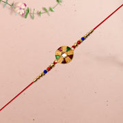 Elegant Multicolor Kundan Rakhi With Golden Floral Round Dial And Beaded Red Thread thumbnail 1