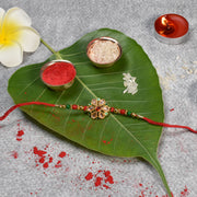 Floral Kundan Rakhi With Red-green Beads And Golden Finish thumbnail 1