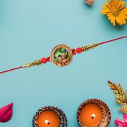 Traditional Krishna Rakhi With Peacock Feather Design And Decorative Beads On Red Thread thumbnail 2