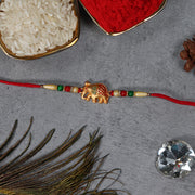 Golden Elephant Rakhi With Red Green Moti thumbnail 3