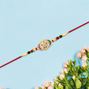 Traditional Oval Rakhi With Kundan Work And Red-green Beads thumbnail 1